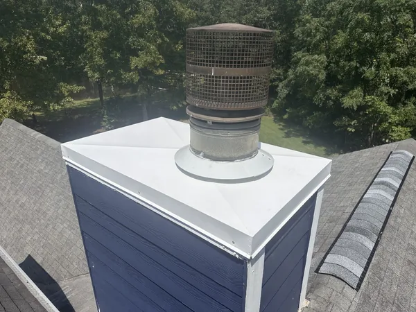 Replacement chase cover around the round chimney termination on the same Alpharetta home