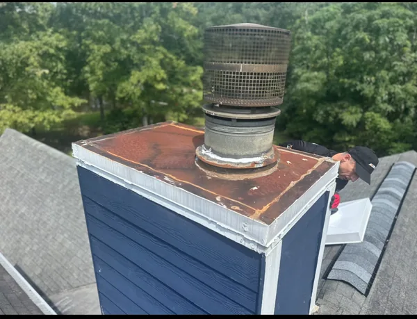Rusted chase cover before replacement on an Alpharetta home