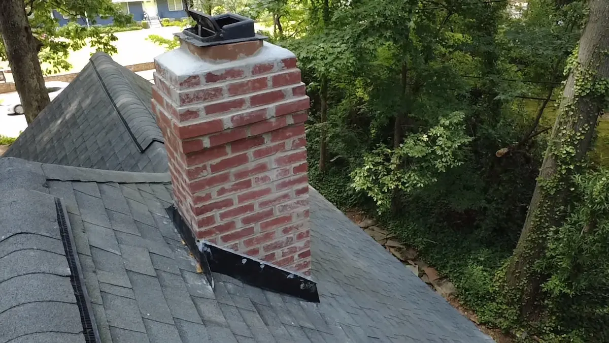 Completed ATL Chimney brick masonry and roofline flashing work on a residential chimney