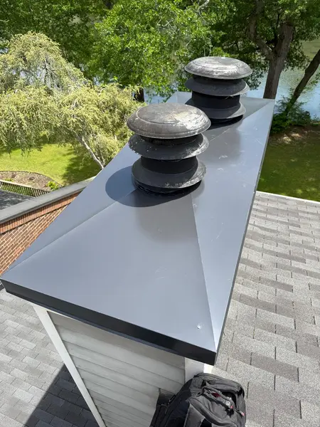 Large custom metal chimney chase cover with three round flue caps